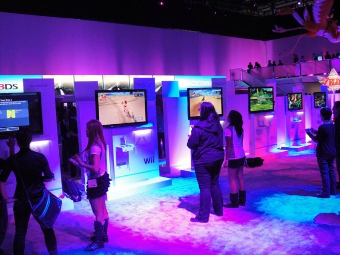 People exploring a Nintendo booth at a conference.