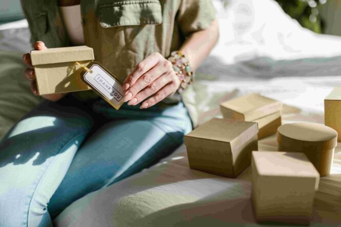 A woman packing event souvenirs in boxes made from sustainable material